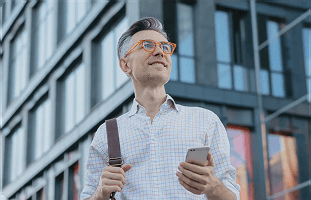 Man checking his phone outdoors